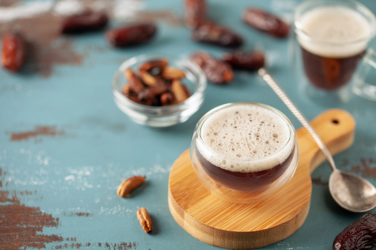 Cup with dates coffee  with date seeds. Healthy plant drink for immunity. Coffee alternatives